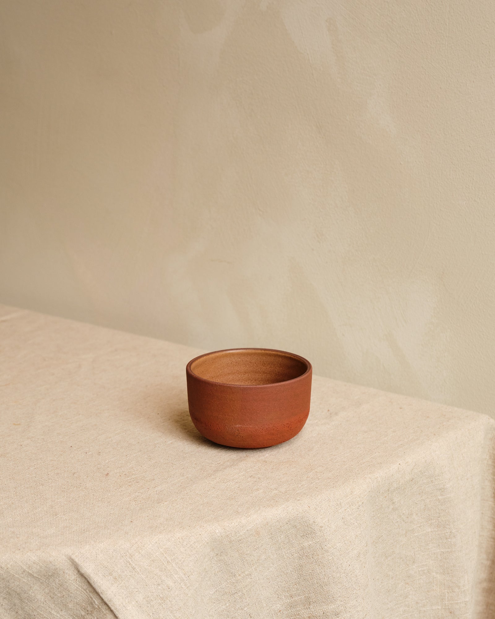 Small bowl on a beige surface with a neutral background