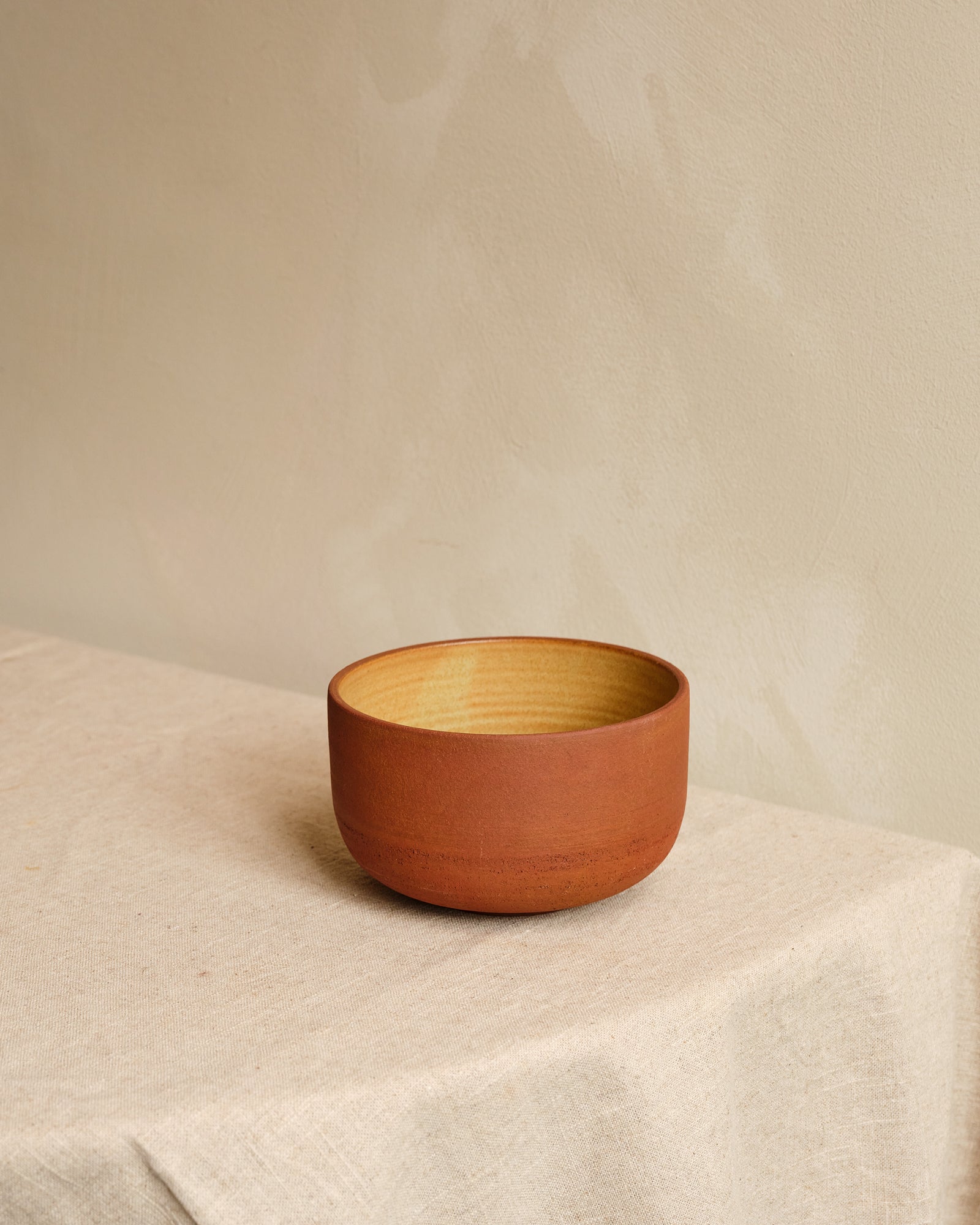 Ramen bowl on a textured beige surface with a neutral background