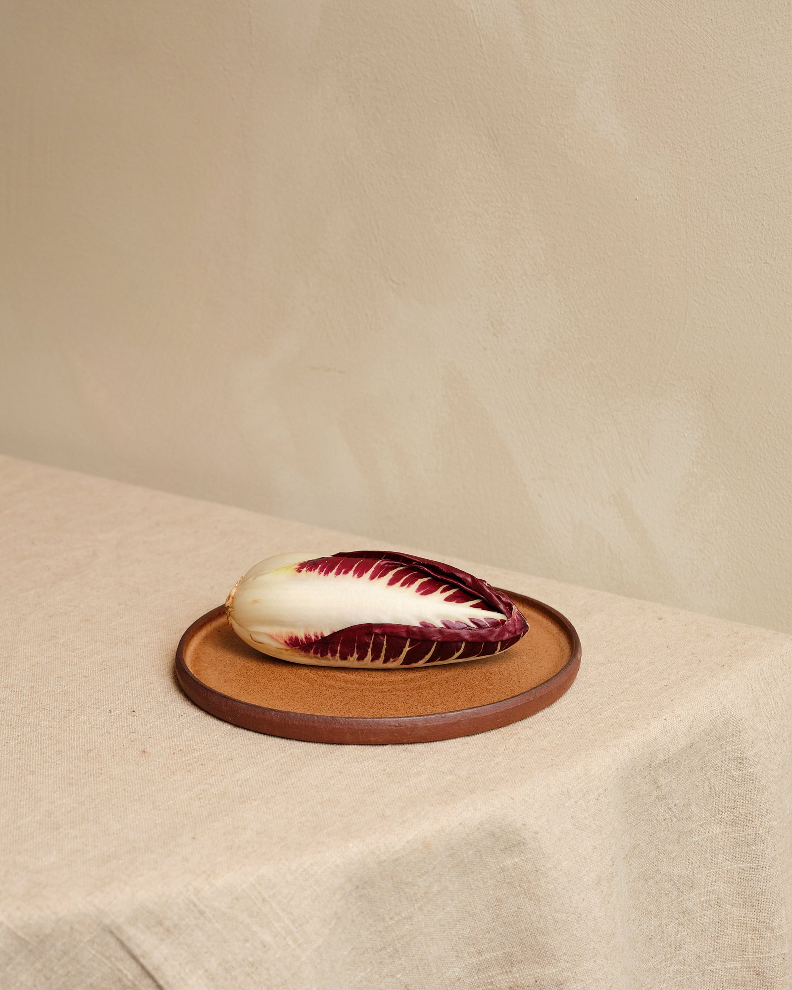 Radicchio on a ceramic plate with a beige background
